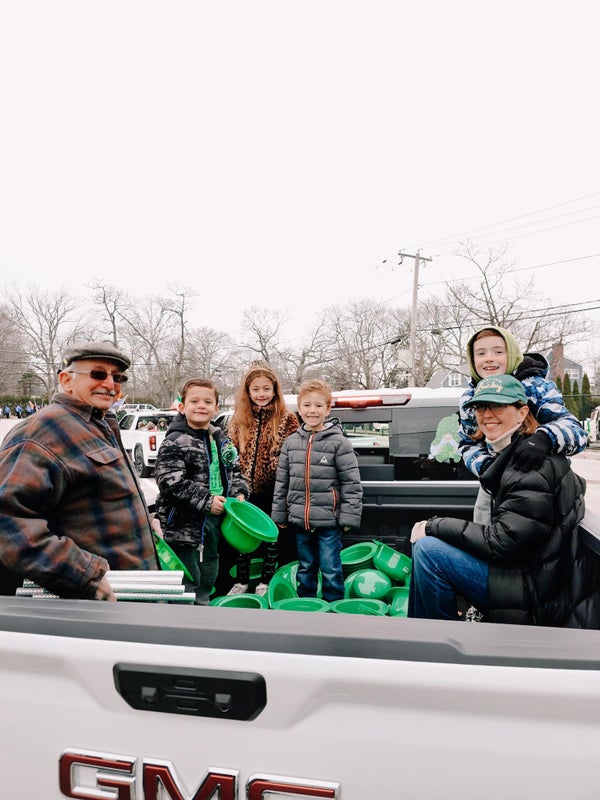 Saint Patrick's Day Parade family with green hats in truck
