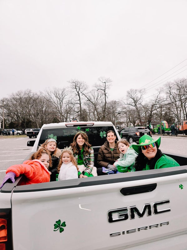 Saint Patrick's Day Parade gmc truck with family in trunk