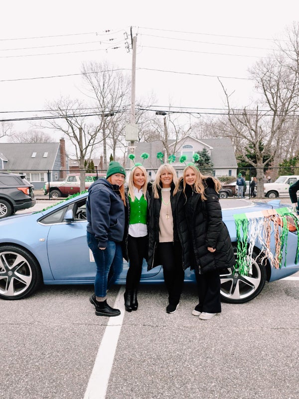 Saint Patrick's Day Parade group photo in front of car